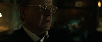 Movie still from “The Marco Effect” (2021), directed by Martin Zandvliet – An older man wearing glasses and a white shirt; Close Up shot, Over the shoulder angle