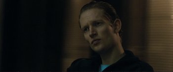 Movie still from “The Marco Effect” (2021), directed by Martin Zandvliet – A person with long hair; Close Up shot, Low angle