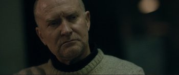 Movie still from “The Marco Effect” (2021), directed by Martin Zandvliet – An older man with a beard is looking at the camera; Close Up shot, Over the shoulder angle