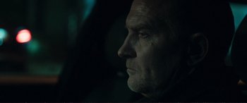 Movie still from “The Marco Effect” (2021), directed by Martin Zandvliet – A man's face in the dark; Close Up shot, Low angle