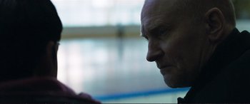 Movie still from “The Marco Effect” (2021), directed by Martin Zandvliet – A man's face in front of a window; Close Up shot, Over the shoulder angle