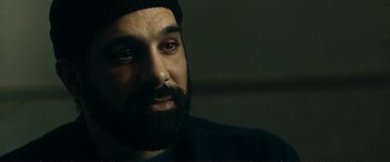 Movie still from “The Marco Effect” (2021), directed by Martin Zandvliet – A man with a beard is looking at the camera; Close Up shot, Over the shoulder angle