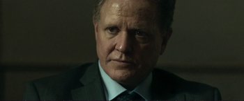 Movie still from “The Marco Effect” (2021), directed by Martin Zandvliet – A person wearing a suit and tie; Close Up shot, Low angle