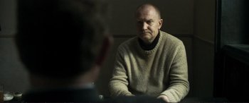 Movie still from “The Marco Effect” (2021), directed by Martin Zandvliet – An older man sitting in front of a mirror; Medium shot, Over the shoulder angle