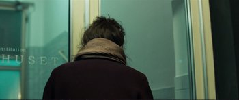 Movie still from “The Marco Effect” (2021), directed by Martin Zandvliet – A person wearing a jacket and a neck scarf; Close Up shot, Over the shoulder angle