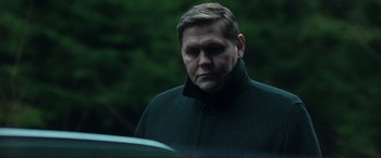 Movie still from “The Marco Effect” (2021), directed by Martin Zandvliet – A person wearing a coat; Close Up shot, Low angle