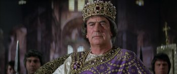 Movie still from “The Message” (1976), directed by Moustapha Akkad – An older man wearing a crown and purple robe; Close Up shot, Low angle