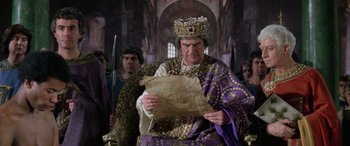 Movie still from “The Message” (1976), directed by Moustapha Akkad – An older man wearing a crown and holding a piece of parchment; Medium shot, Low angle