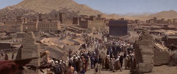 Movie still from “The Message” (1976), directed by Moustapha Akkad – A large group of people gathered in the desert; Extreme Wide shot, High angle