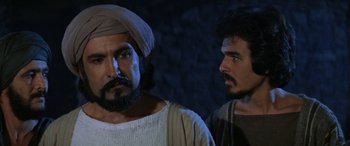 Movie still from “The Message” (1976), directed by Moustapha Akkad – Two men are standing next to each other; Close Up shot, Over the shoulder angle