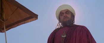 Movie still from “The Message” (1976), directed by Moustapha Akkad – A man with a beard wearing a turban; Medium shot, Low angle