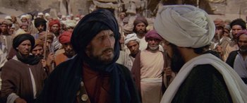 Movie still from “The Message” (1976), directed by Moustapha Akkad – A group of men standing next to each other; Medium shot, Over the shoulder angle