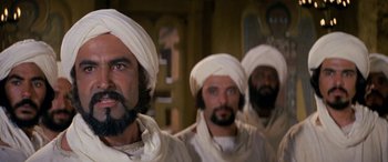 Movie still from “The Message” (1976), directed by Moustapha Akkad – A group of men wearing white turbans and white robes; Close Up shot, Low angle