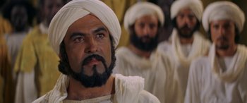 Movie still from “The Message” (1976), directed by Moustapha Akkad – A group of men in white outfits and beards; Close Up shot, Low angle
