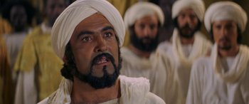 Movie still from “The Message” (1976), directed by Moustapha Akkad – A man with a beard and a turban is looking straight ahead while another man with a beard and a turban is looking straight ahead; Close Up shot, Over the shoulder angle