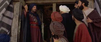 Movie still from “The Message” (1976), directed by Moustapha Akkad – A group of men standing next to each other; Medium shot, Over the shoulder angle