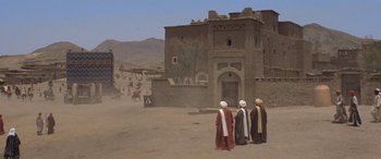 Movie still from “The Message” (1976), directed by Moustapha Akkad – A group of men standing in front of a building; Extreme Wide shot, High angle