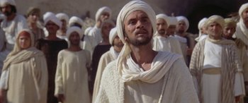 Movie still from “The Message” (1976), directed by Moustapha Akkad – A group of men in white clothes and white hats; Medium shot, Low angle