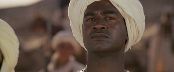Movie still from “The Message” (1976), directed by Moustapha Akkad – A person wearing a turban; Close Up shot, Low angle