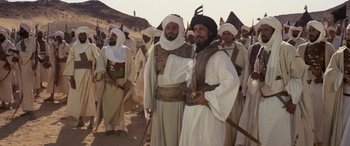 Movie still from “The Message” (1976), directed by Moustapha Akkad – A group of men standing next to each other on top of a hill; Wide shot, Low angle