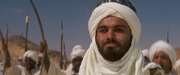 Movie still from “The Message” (1976), directed by Moustapha Akkad – A man with a beard and a white turban on; Close Up shot, Low angle