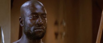 Movie still from “The Message” (1976), directed by Moustapha Akkad – A man's face in a dark room; Close Up shot, Low angle