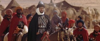 Movie still from “The Message” (1976), directed by Moustapha Akkad – A group of men riding horses in a desert; Medium shot, Low angle