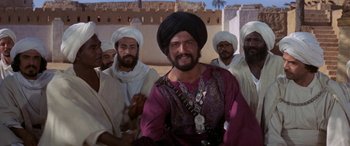 Movie still from “The Message” (1976), directed by Moustapha Akkad – A group of men standing next to each other; Medium shot, Over the shoulder angle