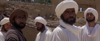 Movie still from “The Message” (1976), directed by Moustapha Akkad – A couple of men standing next to each other; Close Up shot, Low angle