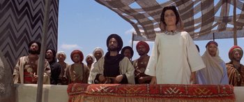 Movie still from “The Message” (1976), directed by Moustapha Akkad – A group of men and women standing on top of a tent; Wide shot, Low angle