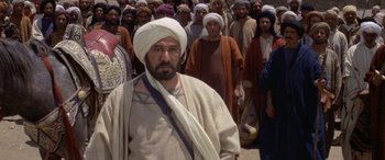 Movie still from “The Message” (1976), directed by Moustapha Akkad – A group of men standing next to each other; Medium shot, Over the shoulder angle