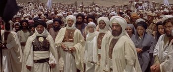 Movie still from “The Message” (1976), directed by Moustapha Akkad – A large group of men in white robes and turbans; Wide shot, High angle