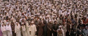 Movie still from “The Message” (1976), directed by Moustapha Akkad – A large group of men in white robes and white hats; Extreme Wide shot, High angle