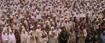 Movie still from “The Message” (1976), directed by Moustapha Akkad – A large group of men in white clothes and white hats; Extreme Wide shot, High angle