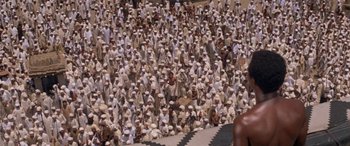 Movie still from “The Message” (1976), directed by Moustapha Akkad – A large group of people gathered together for a gathering; Extreme Wide shot, High angle