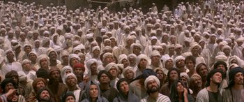 Movie still from “The Message” (1976), directed by Moustapha Akkad – A large group of people wearing white hats; Extreme Wide shot, High angle