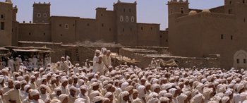 Movie still from “The Message” (1976), directed by Moustapha Akkad – A large group of men in white robes and white hats; Extreme Wide shot, High angle