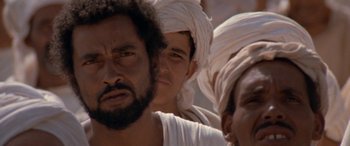Movie still from “The Message” (1976), directed by Moustapha Akkad – A group of men in white shirts and turbans; Close Up shot, Low angle