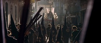 Movie still from “The Moment of Truth” (1965), directed by Francesco Rosi – A group of people dressed in black and wearing black hoods; Extreme Wide shot, High angle