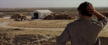 Movie still from “The Moment of Truth” (1965), directed by Francesco Rosi – A man standing in the middle of an open field; Wide shot, Over the shoulder angle