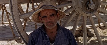 Movie still from “The Moment of Truth” (1965), directed by Francesco Rosi – An old man wearing a straw hat and a blue shirt; Close Up shot, High angle