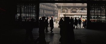 Movie still from “The Moment of Truth” (1965), directed by Francesco Rosi – A group of people walking on a sidewalk; Extreme Wide shot, High angle