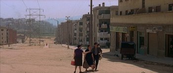 Movie still from “The Moment of Truth” (1965), directed by Francesco Rosi – A group of people walking down a street; Extreme Wide shot, High angle