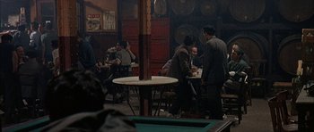 Movie still from “The Moment of Truth” (1965), directed by Francesco Rosi – A group of people sitting at a table in a room; Wide shot, High angle