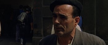 Movie still from “The Moment of Truth” (1965), directed by Francesco Rosi – A person wearing a hat; Close Up shot, Over the shoulder angle