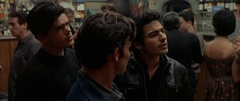 Movie still from “The Moment of Truth” (1965), directed by Francesco Rosi – A group of men standing next to each other in a room; Medium shot, Over the shoulder angle