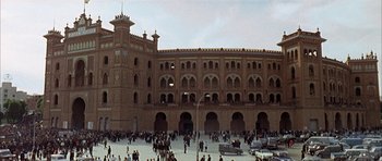 Movie still from “The Moment of Truth” (1965), directed by Francesco Rosi – A crowd of people standing in front of a large building; Extreme Wide shot, High angle