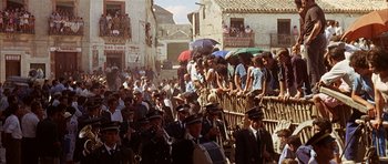 Movie still from “The Moment of Truth” (1965), directed by Francesco Rosi – A crowd of people standing on top of a wooden fence; Extreme Wide shot, High angle