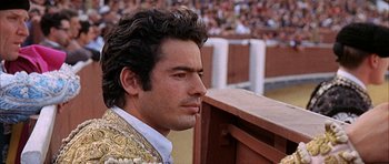 Movie still from “The Moment of Truth” (1965), directed by Francesco Rosi – A person wearing a suit; Close Up shot, Low angle