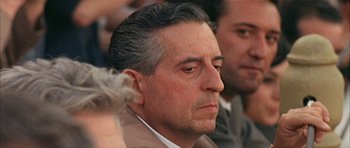 Movie still from “The Moment of Truth” (1965), directed by Francesco Rosi – An older man with a beard and a mustache; Close Up shot, Over the shoulder angle